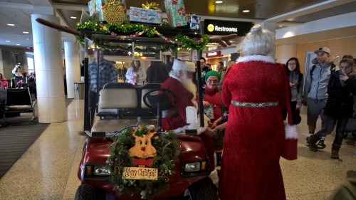 Santa mobile cart with Mrs. Claus and elf sidekicks at SEATAC